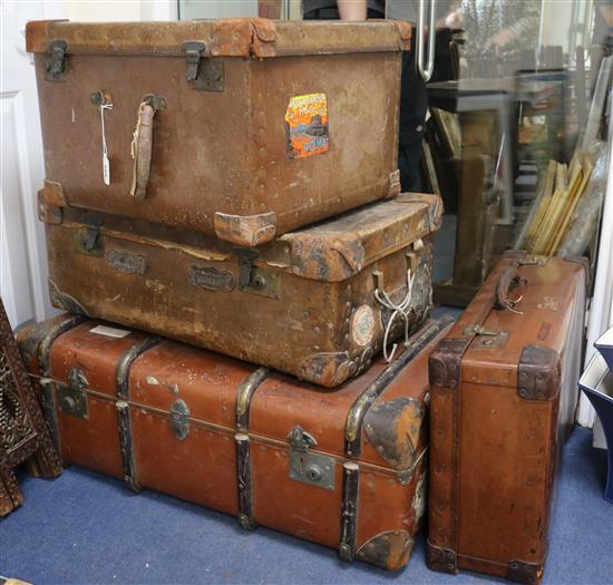 A group of four suitcases and a hat case